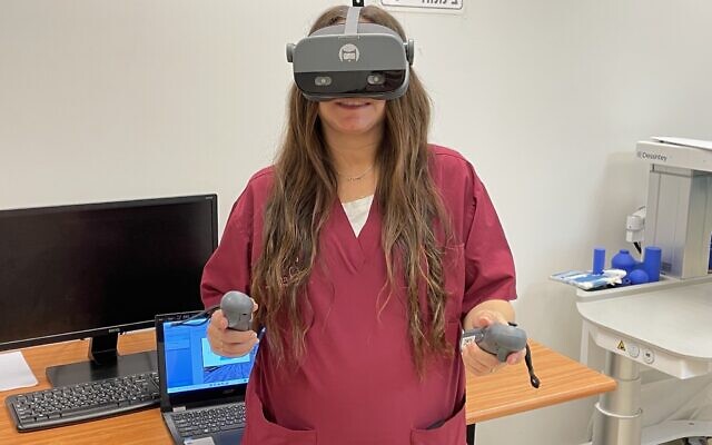 Occupational Therapist Chen Ben Dan demonstrates the XRHealth therapeutic virtual reality system, Sheba Medical Center, December 28, 2023. (Renee Ghert-Zand/Times of Israel) Occupational Therapist Chen Ben Dan demonstrates the XRHealth therapeutic virtual reality system, Sheba Medical Center, December 28, 2023. (Renee Ghert-Zand/Times of Israel)