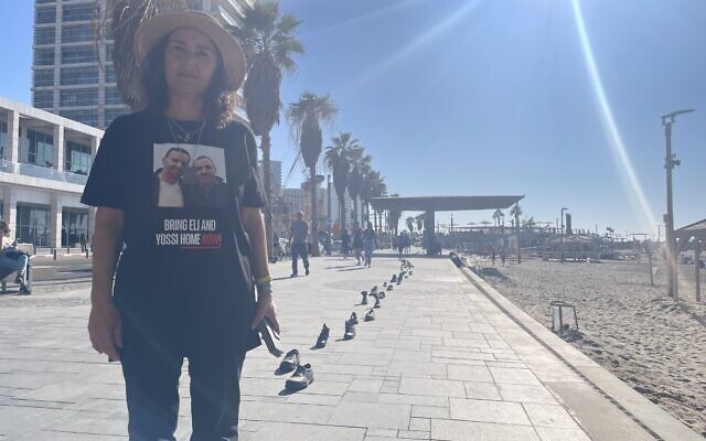 Osnat Sharabi set up hundreds of shoes on the Tel Aviv boardwalk to make people think about what it's like to be in the hostages' proverbial shoes, including her brothers, Yossi and Eli Sharabi, taken hostage on October 7, 2023 (Jessica Steinberg/Times of Israel)