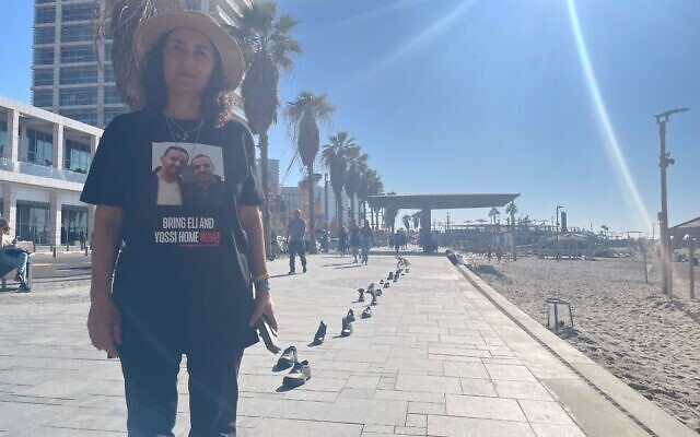 Osnat Sharabi, whose brothers Yossi and Eli are hostages in Gaza, next to a new exhibition of shoes in Tel Aviv on January 7, 2024. (Jessica Steinberg/Times of Israel) Osnat Sharabi, whose brothers Yossi and Eli are hostages in Gaza, next to a new exhibition of shoes in Tel Aviv on January 7, 2024. (Jessica Steinberg/Times of Israel)