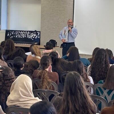 Tzvika Mor lectures to students at the Tohar religious Zionist high school for girls in Yad Binyamin on December 25, 2023. (Mati Wagner)