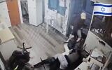 Screen capture from video showing two Israeli security guards struggling for control of a rifle seized by a terrorist during a stabbing attack, January 1, Mishor Adumim. (X. Used in accordance with Clause 27a of the Copyright Law)