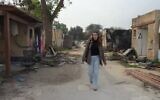 Resident Ori Lupo walking among the ruins of Kibbutz Kfar Aza. (Channel 12 screenshot; used in accordance with Clause 27a of the Copyright Law)