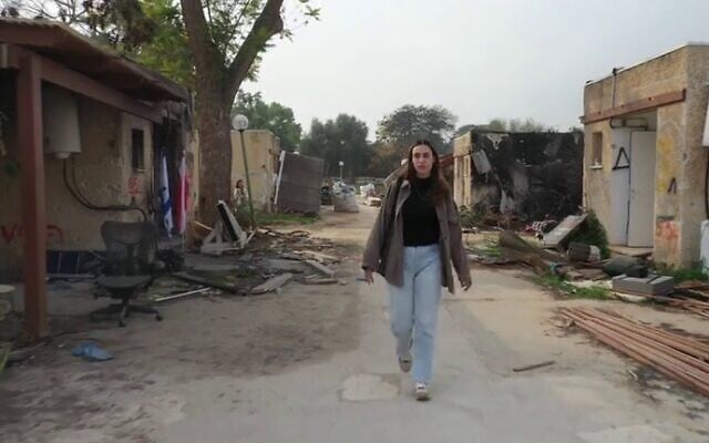 Resident Ori Lupo walking among the ruins of Kibbutz Kfar Aza. (Channel 12 screenshot; used in accordance with Clause 27a of the Copyright Law)