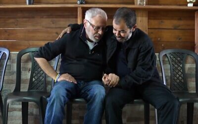 Avi Shamriz (L) and Fouad Talalka, fathers of hostages killed by mistake by Israeli troops in Gaza, meet for the first time, in a report aired January 5, 2024. (Kan news screenshot: used in accordance with Clause 27a of the Copyright Law)