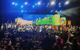 Settlement activists at a conference in Jerusalem to promote the construction of Jewish settlements in Gaza go up on stage in dedicated groups that seek to establish six new settlements in the coastal enclave, January 28, 2024. (Courtesy the Nachala Settlement Movement)