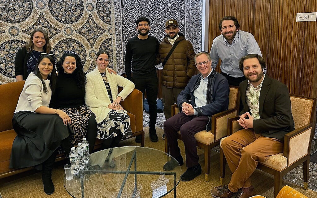 Members of a conversion program meeting in New York City on December 21, 2023. Jasamine Hodge is seated in the center in a white sweater, with her fiancé Adir standing to her left. Seated on the right are Rabbis Adam Mintz and Avram Mlotek. (Courtesy of Hodge via JTA) Members of a conversion program meeting in New York City on December 21, 2023. Jasamine Hodge is seated in the center in a white sweater, with her fiancé Adir standing to her left. Seated on the right are Rabbis Adam Mintz and Avram Mlotek. (Courtesy of Hodge via JTA)