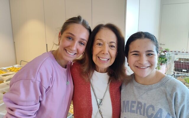 Shekoufeh 'Chicki' Elghanian, center, and volunteers at her Herzliya apartment, on December 28, 2023. (Gavriel Fiske/TOI)