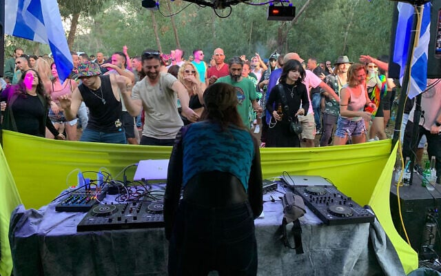 Israeli flags flank the DJ stage at the Dragonfly trance music festival near Modiin on January 6, 2024. (Dragonfly)