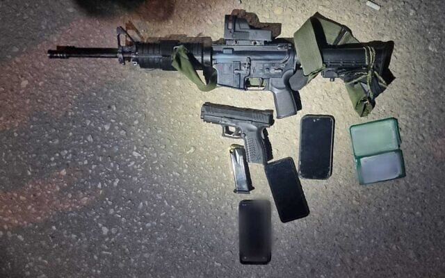 Weapons seized from a wanted Palestinian gunman following a raid in the West Bank town of Iktaba, January 8, 2024. (Israel Police)