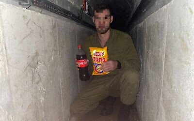 An IDF soldier with Bamba and Coke in what appears to be a Hamas tunnel in Gaza, part of the 'Operation Juha' civilian charity initiative, in an undated photo. (courtesy)