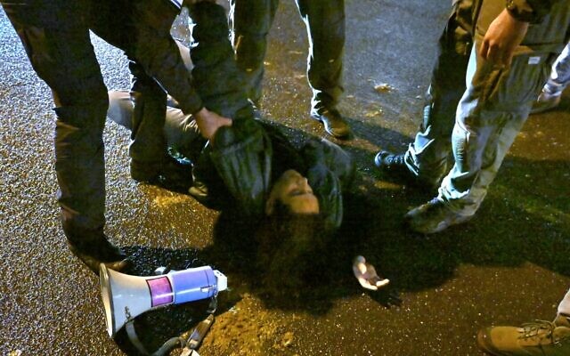 An anti-government protester is arrested at a rally in Tel Aviv after demonstrators blocked Kaplan Street and prevented traffic from passing, January 27, 2024. (Ben Cohen) An anti-government protester is arrested at a rally in Tel Aviv after demonstrators blocked Kaplan Street and prevented traffic from passing, January 27, 2024. (Ben Cohen)
