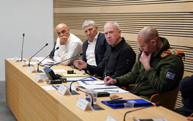 Defense Minister Yoav Gallant (center) speaks during an assessment at the Kiryat Ata municipality, January 30, 2024. (Ariel Hermoni/Defense Ministry)