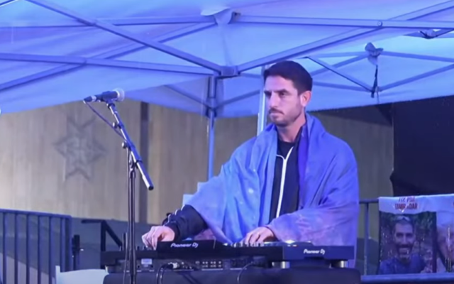 Trance music producer Omri Sasi showcases his latest set during a rally in Tel Aviv on January 14, 2024. (Screen capture/Youtube)