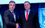 Outgoing Foreign Minister Eli Cohen (L) and his replacement Israel Katz shake hands at the ceremony in Jerusalem marking the handover, January 2, 2024. (Shlomi Amsalem/Foreign Ministry)
