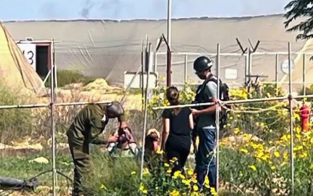 Nasreen Youssef filmed talking to Hamas terrorists near the yard of her home on Moshav Yated, close to the southern Gaza border, October 7, 2023. (Screenshot taken from Channel 12/Keshet TV, used in accordance with Clause 27a of the Copyright Law).
