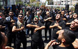Shiite Muslim devotees participate in a mourning procession in Tehran on September 6, 2023, to observe Arbaeen, which marks the end of the 40-day mourning period for the killing of Imam Hussein, a founding figure in Shiite Islam and the grandson of the Prophet Mohammed, by the forces of the caliph Yazid in 680 AD. (Photo by AFP)