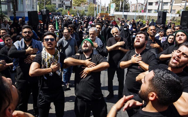 Shiite Muslim devotees participate in a mourning procession in Tehran on September 6, 2023, to observe Arbaeen, which marks the end of the 40-day mourning period for the killing of Imam Hussein, a founding figure in Shiite Islam and the grandson of the Prophet Mohammed, by the forces of the caliph Yazid in 680 AD. (Photo by AFP) Shiite Muslim devotees participate in a mourning procession in Tehran on September 6, 2023, to observe Arbaeen, which marks the end of the 40-day mourning period for the killing of Imam Hussein, a founding figure in Shiite Islam and the grandson of the Prophet Mohammed, by the forces of the caliph Yazid in 680 AD. (Photo by AFP)