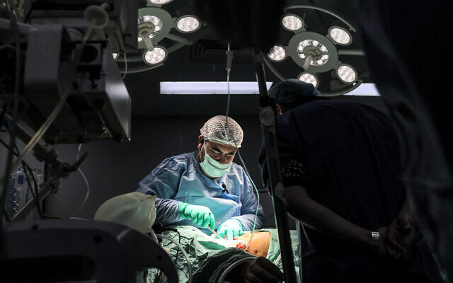 A surgeon operates on a patient in a surgery operating theatre at the Gaza European Hospital in Khan Yunis in the southern Gaza Strip on December 31, 2023. (AFP) A surgeon operates on a patient in a surgery operating theatre at the Gaza European Hospital in Khan Yunis in the southern Gaza Strip on December 31, 2023. (AFP)