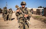 File: US soldiers patrol an area in the town of Tal Hamis, southeast of the city of Qameshli in Syria's northeastern Hasakeh governorate, on January 24, 2024. (Delil Souleiman/AFP)