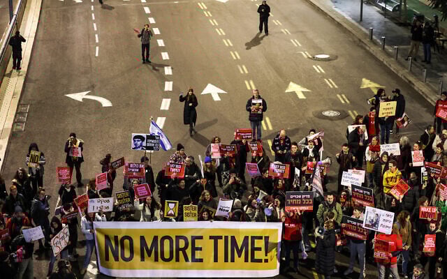 Demonstrators block a main road demanding an immediate deal for the release Israeli hostages held in the Gaza Strip by Palestinian terrorists, during a protest near the Defense Ministry in Tel Aviv on February 1, 2024. (AHMAD GHARABLI / AFP