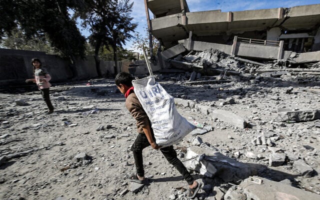 Illustrative: A boy carries a sack bearing the logo of the United Nations Relief and Works Agency for Palestine Refugees in the Near East (UNRWA) in the Nuseirat camp in the Gaza Strip. (Anas Baba/AFP)