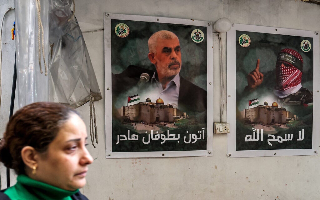 A woman walks past posters depicting Yahya Sinwar (L), the head of Hamas in the Gaza Strip, and Abu Obeida (R), the masked spokesman of Hamas's Qassam Brigades, plastered on a wall in the Burj al-Barajneh camp for Palestinian refugees in Beirut's southern suburb on February 5, 2024. (ANWAR AMRO / AFP) A woman walks past posters depicting Yahya Sinwar (L), the head of Hamas in the Gaza Strip, and Abu Obeida (R), the masked spokesman of Hamas's Qassam Brigades, plastered on a wall in the Burj al-Barajneh camp for Palestinian refugees in Beirut's southern suburb on February 5, 2024. (ANWAR AMRO / AFP)