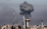 This picture taken from Rafah in the southern Gaza Strip, shows smoke rising over buildings in Khan Younis during Israeli bombardment on February 8, 2024, as fighting continues between Israel and the Palestinian terror group Hamas. (Mahmud Hams/AFP)