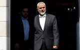 File: This handout picture provided by the Iranian foreign ministry on February 13, 2024, shows Hamas political bureau chief Ismail Haniyeh preparing to welcome the Iranian foreign minister in Doha. (Iranian Foreign Ministry/AFP)