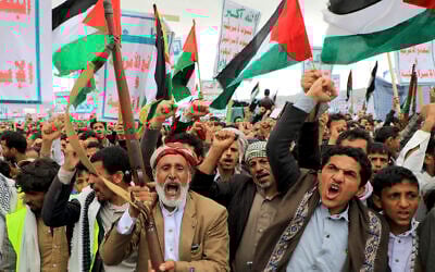 Yemenis brandishing weapons chant slogans and wave Palestinian flags as they march in the Houthi-run capital Sanaa on February 16, 2024 (MOHAMMED HUWAIS / AFP)