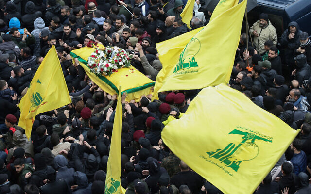 Illustrative: Hezbollah supporters attend the funeral of Ali al-Debs, one of the terror group's commanders killed by an Israeli air raid two days earlier, in Lebanon's southern city of Nabatieyh on February 16, 2024.  (Photo by MAHMOUD ZAYYAT / AFP)