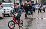 A man rides a bicycle in Rafah in southern Gaza, on February 18, 2024. (SAID KHATIB / AFP)