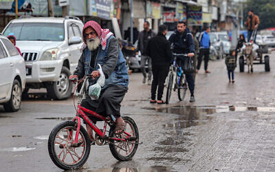 A man rides a bicycle in Rafah in southern Gaza, on February 18, 2024. (SAID KHATIB / AFP)