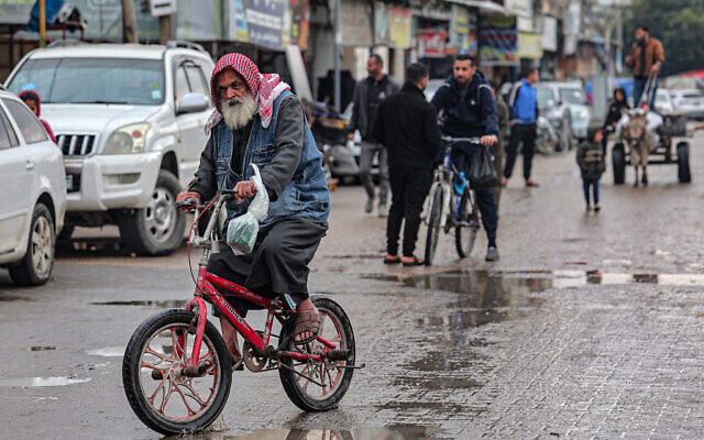 A man rides a bicycle in Rafah in southern Gaza, on February 18, 2024. (SAID KHATIB / AFP)