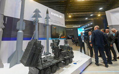 Guests stand next to the Rafael Advanced Defense Systems booth at the Singapore Airshow in Singapore on February 21, 2024. (Roslan Rahman / AFP)