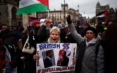 Pro-Palestinian, anti-Israel demonstrators wave Palestinian flags and hold placards as they protest in Parliament Square in London on February 21, 2024, during an Opposition Day motion in the House of Commons calling for an immediate ceasefire in Gaza. (Henry Nicholls/AFP)