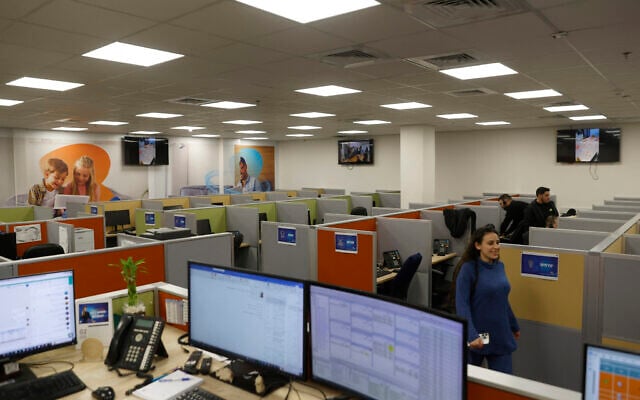 Illustrative: Employees work inside the offices of the Bezeq telecoms firm in the northern Israeli city of Kiryat Shmona near the border with Lebanon on February 22, 2024. - The deadly exchanges of fire between Israel and Lebanon have prompted most people in communities on both sides of the heavily fortified border to leave but some employees of the firm have decided to stay. (Photo by Jalaa MAREY / AFP) Illustrative: Employees work inside the offices of the Bezeq telecoms firm in the northern Israeli city of Kiryat Shmona near the border with Lebanon on February 22, 2024. - The deadly exchanges of fire between Israel and Lebanon have prompted most people in communities on both sides of the heavily fortified border to leave but some employees of the firm have decided to stay. (Photo by Jalaa MAREY / AFP)