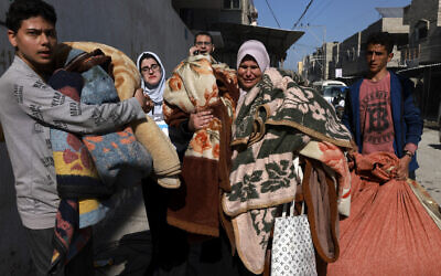 Palestinians flee their homes along with their belongings following Israeli strikes in Rafah in the southern Gaza Strip on February 24, 2024. (MOHAMMED ABED / AFP)