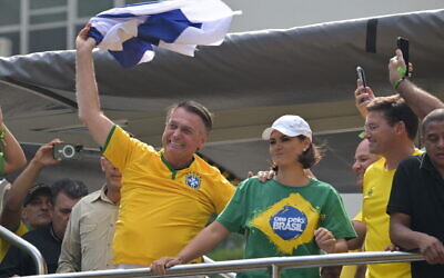 File - Former Brazilian President Jair Bolsonaro greets supporters while waving an Israeli flag during a rally in Sao Paulo, Brazil, February 25, 2024. (Nelson Almeida/AFP)