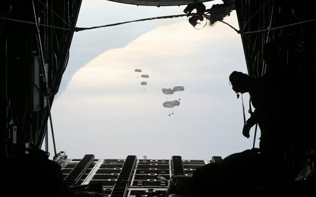 A handout picture provided by the Jordanian army on February 26, 2024, shows a Jordanian military aircraft dropping humanitarian aid over the southern Gaza Strip. (Jordanian army/AFP) A handout picture provided by the Jordanian army on February 26, 2024, shows a Jordanian military aircraft dropping humanitarian aid over the southern Gaza Strip. (Jordanian army/AFP)