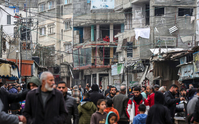 Palestinians walk in the Maghazi camp for Palestinian refugees, in the central Gaza Strip on February 27, 2024, amid the ongoing war between Israel and the Palestinian terror group Hamas. (AFP) Palestinians walk in the Maghazi camp for Palestinian refugees, in the central Gaza Strip on February 27, 2024, amid the ongoing war between Israel and the Palestinian terror group Hamas. (AFP)