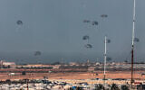 A Jordanian military aircraft (not pictured) drops humanitarian aid over Rafah and Khan Younis in the skies of the southern Gaza Strip on February 27, 2024. (Said Khatib/AFP)