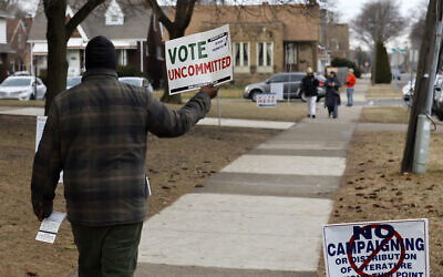Illustrative: a volunteer asks people to vote 'uncommitted,' instead of for US President Joe Biden, outside of McDonald Elementary School in Dearborn during the Michigan presidential primary election on February 27, 2024. (Jeff Kowalsky/AFP)