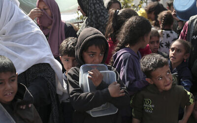 Displaced Palestinians gather for food in Rafah, on the southern Gaza Strip on February 28, 2024, amid ongoing battles between Israel and Hamas. (AFP).