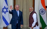 India's Prime Minister Narendra Modi, right, gestures and Israeli Prime Minister Benjamin Netanyahu waves to the media as they arrive for a meeting in New Delhi, India, Jan.15, 2018. (AP Photo, File)
