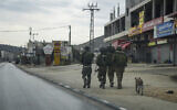 Illustrative: Israeli soldiers on patrol in the flashpoint Palestinian town of Huwara on November 12, 2023. (AP Photo/Mahmoud Illean)