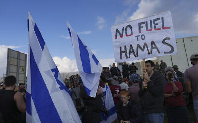 Police prevent activists from blocking trucks carrying humanitarian aid into the Gaza Strip at the Kerem Shalom border crossing between Israel and Gaza, in southern Israel, January 29, 2024. (AP/ Tsafrir Abayov)