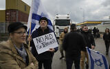 File - Protesters block the exit of Ashdod port to stop trucks they claim are carrying humanitarian aid destined for the Gaza Strip, in Ashdod, February 1, 2024. (AP Photo/Leo Correa)