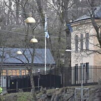 Officers stand near the Israeli Embassy in Stockholm, Sweden, January 31, 2024. (Henrik Montgomery/TT News Agency via AP)