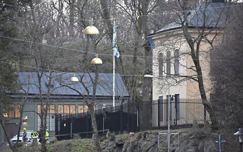 Officers stand near the Israeli Embassy in Stockholm, Sweden, January 31, 2024. (Henrik Montgomery/TT News Agency via AP)