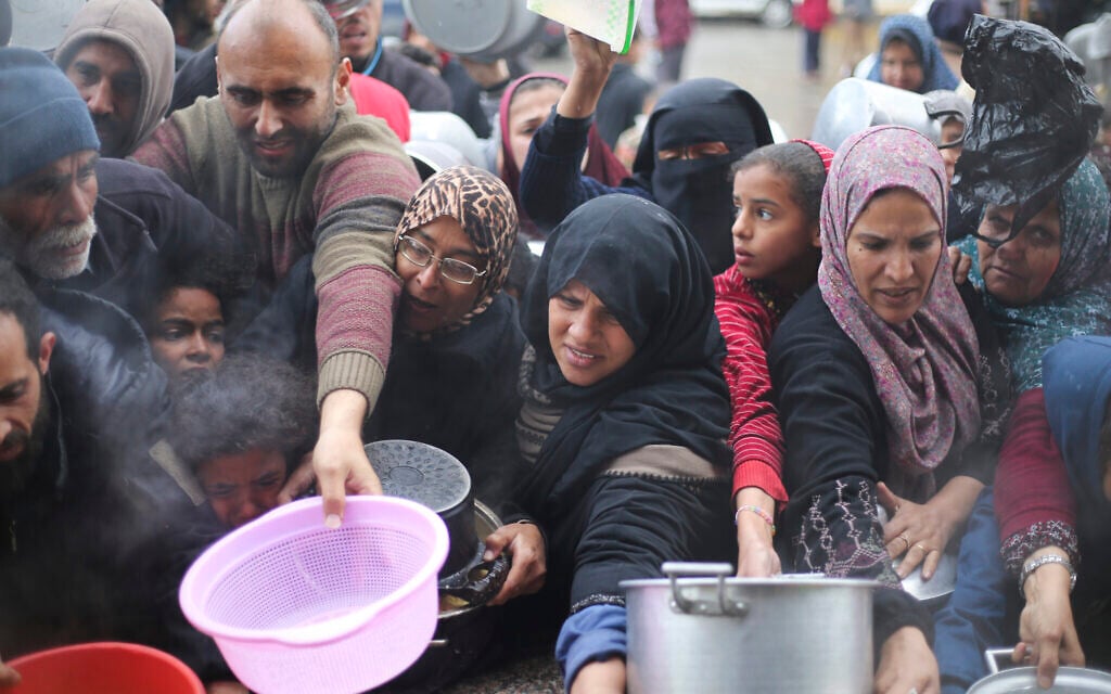Illustrative: Palestinians line up for food distribution in Khan Younis, Gaza Strip, February 2, 2024. (AP Photo/Hatem Ali)